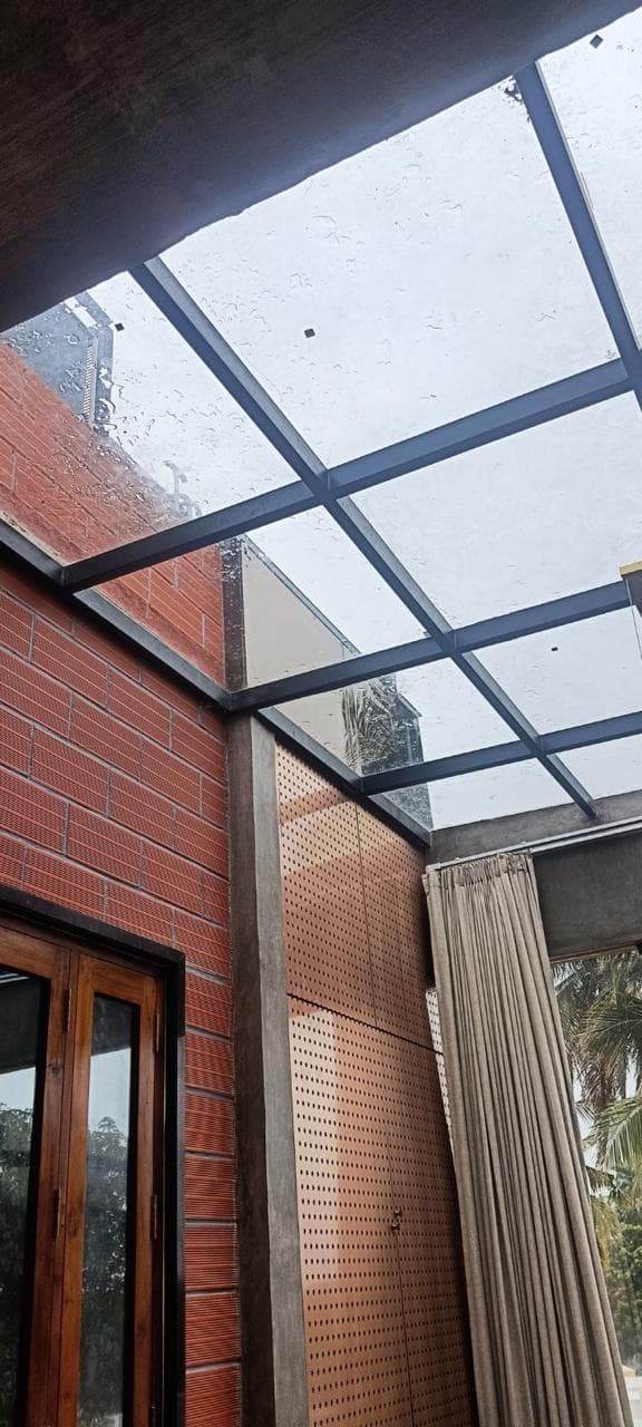 Looking up through the glazed atrium roof at the exposed brick and concrete structure.